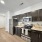 Open Kitchen With Stainless Steel Appliances and Glass-top Stove